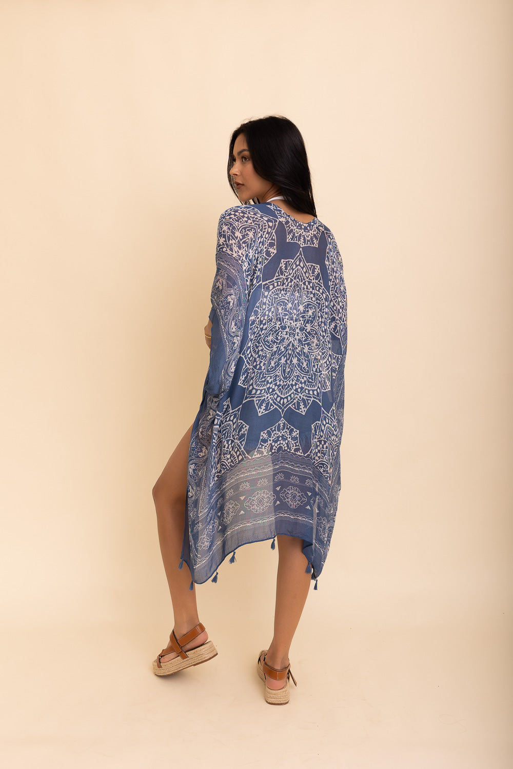 A stylish Mandala Tassel Kimono featuring vibrant mandala patterns and playful tassels, perfect for beach outings.