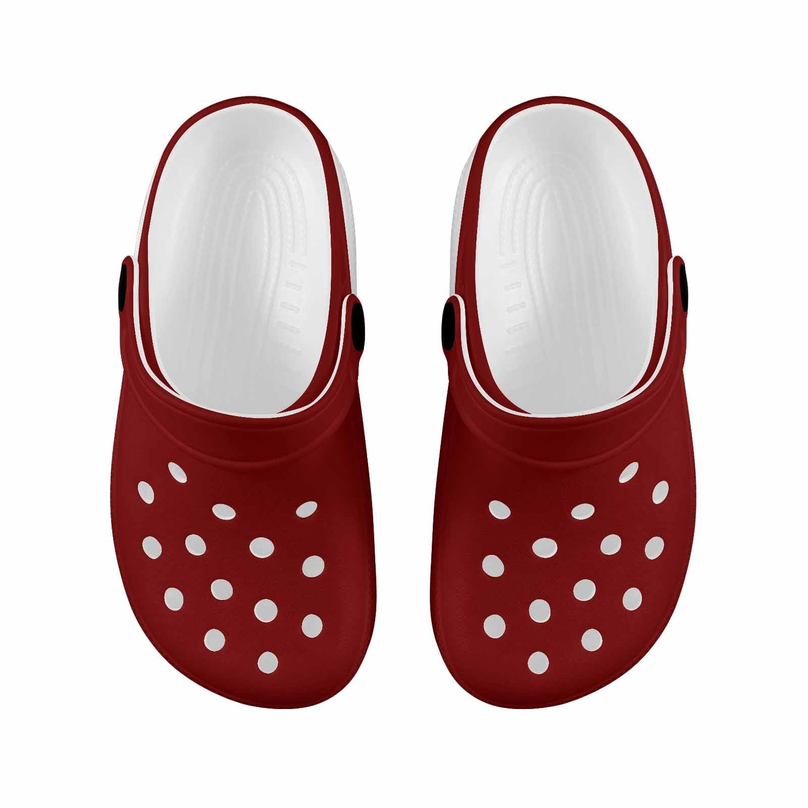 A pair of maroon red clogs designed for youth, featuring a slip-on design, ventilation ports, and cushioned sole for comfort.