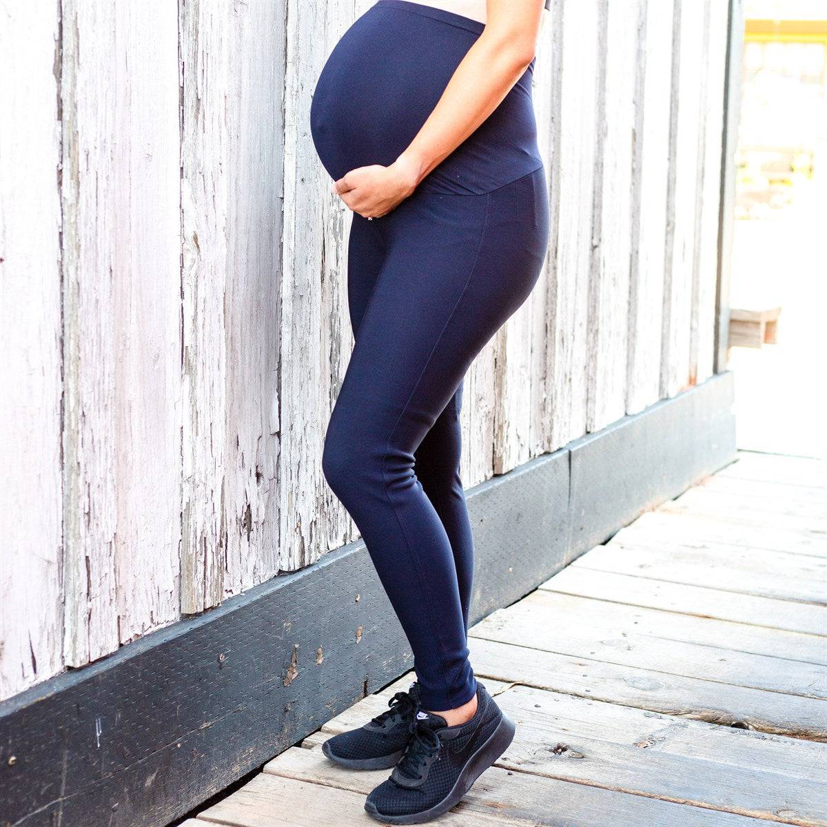 A pair of stylish black maternity leggings featuring a seamless stretch panel and extra tall waistband for support during pregnancy.