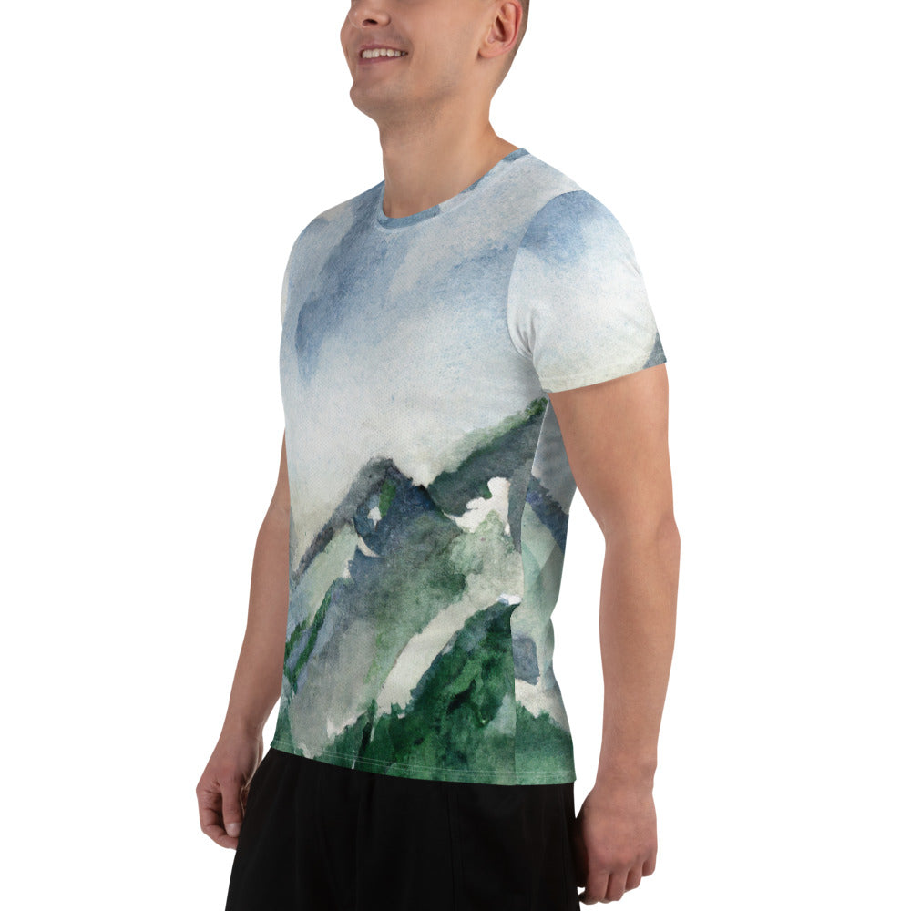 Men's Stretch Fit Athletic Sports T-shirt featuring a green mountainside nature landscape print against a blue sky.