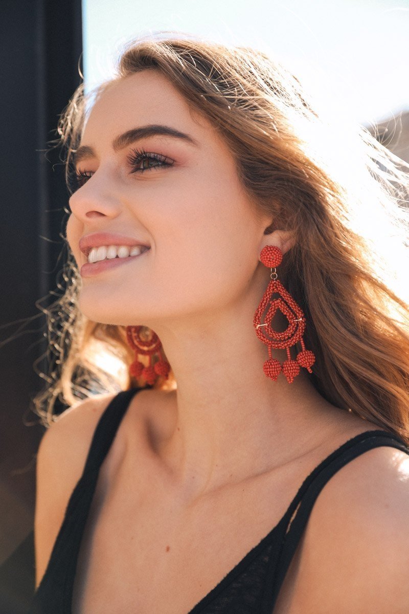 A pair of bold Micro Bead Dangle Earrings featuring colorful acrylic beads and brass accents, showcasing a modern boho style.