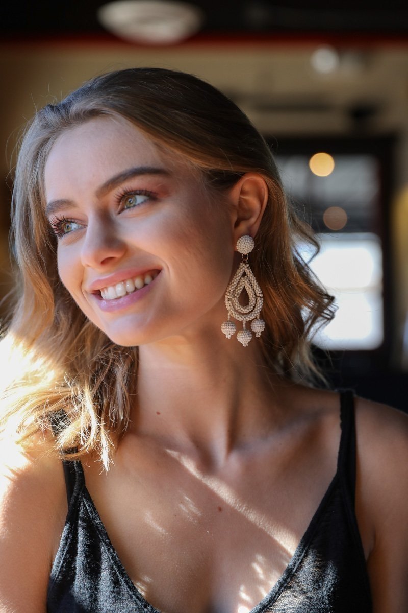 A pair of bold Micro Bead Dangle Earrings featuring colorful acrylic beads and brass accents, showcasing a modern boho style.