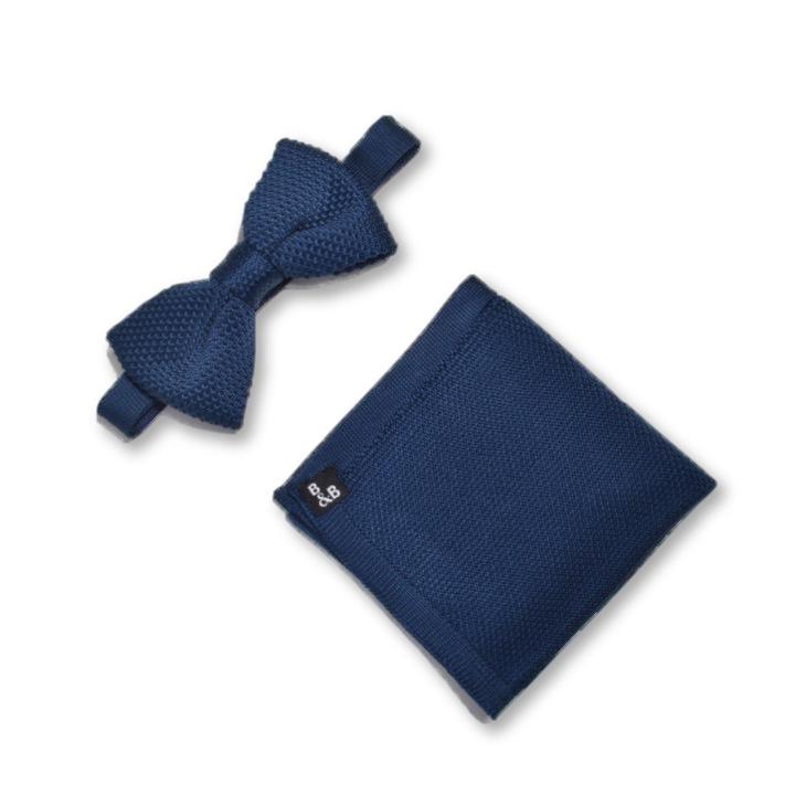 Midnight blue knitted bow tie and pocket square set displayed elegantly, showcasing the rich color and texture.