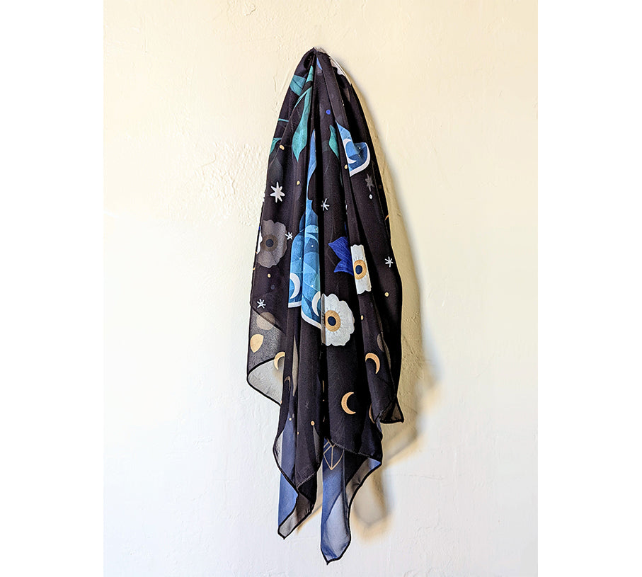 A beautifully designed Midnight Garden Scarf featuring a mystical night theme, made from 100% recycled vegan silk, perfect for various styling options.