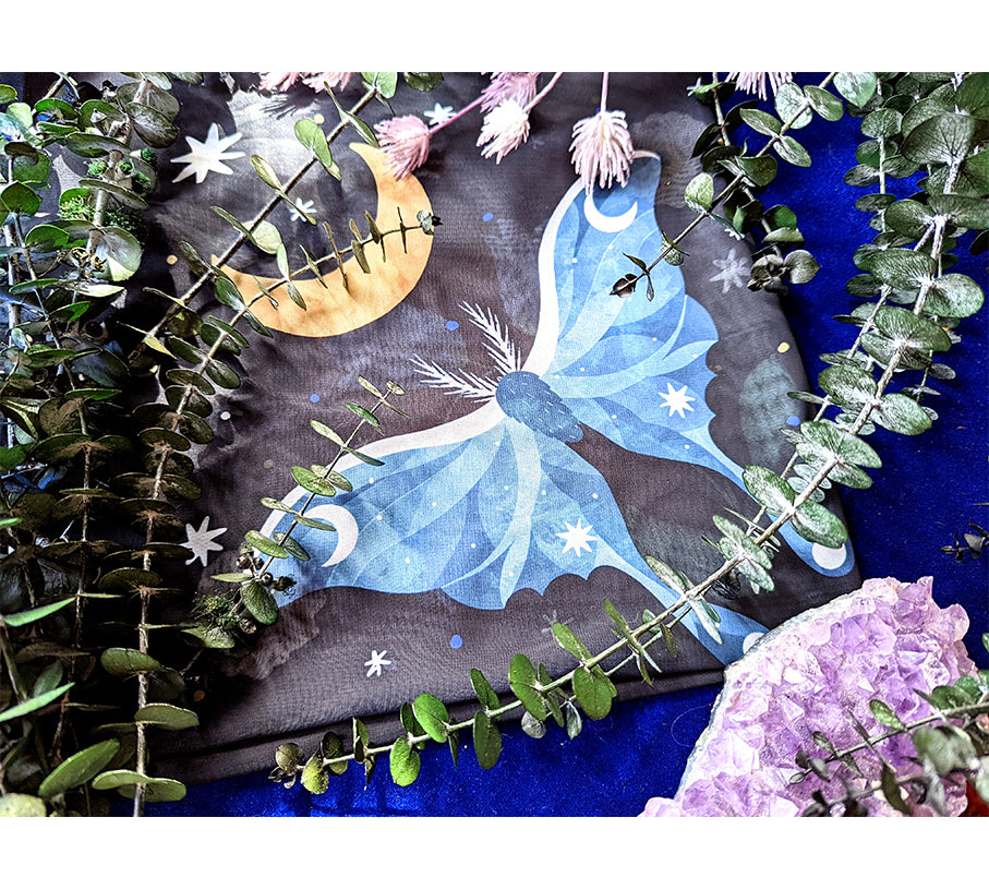 A beautifully designed Midnight Garden Scarf featuring a mystical night theme, made from 100% recycled vegan silk, perfect for various styling options.