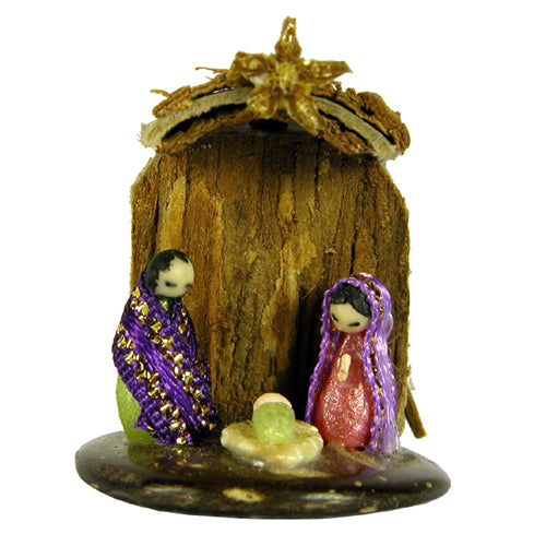 Miniature nativity scene featuring Mary, Joseph, and Baby made from seeds and ribbon, set on a coconut base with Cat's Claw Bark.