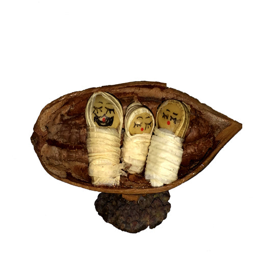 Miniature Nativity set featuring Mary, Joseph, and Baby made from seed pods and corn husk, showcasing eco-friendly craftsmanship.