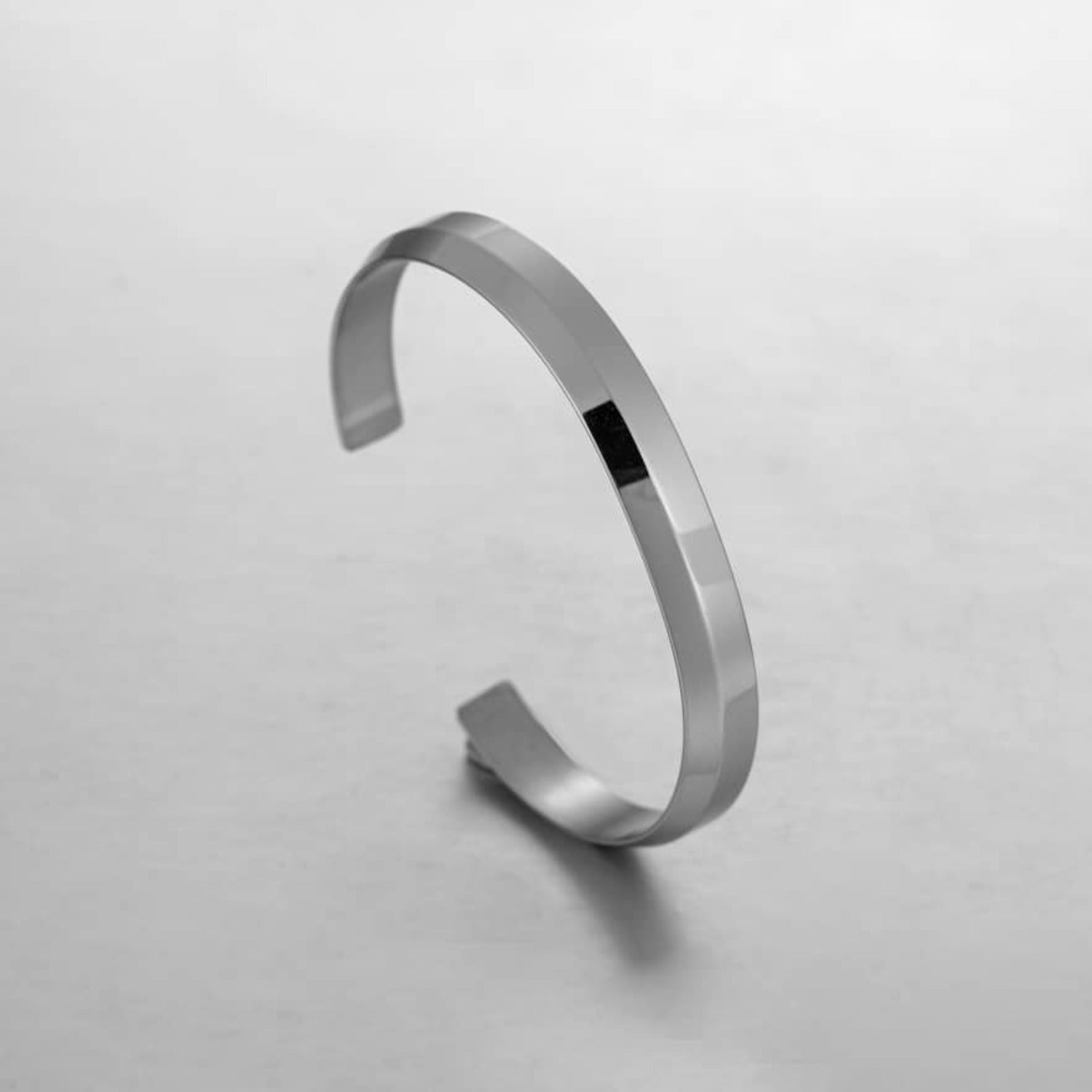 A sleek silver minimalist classic bracelet made from stainless steel, showcasing its elegant design and available sizes.