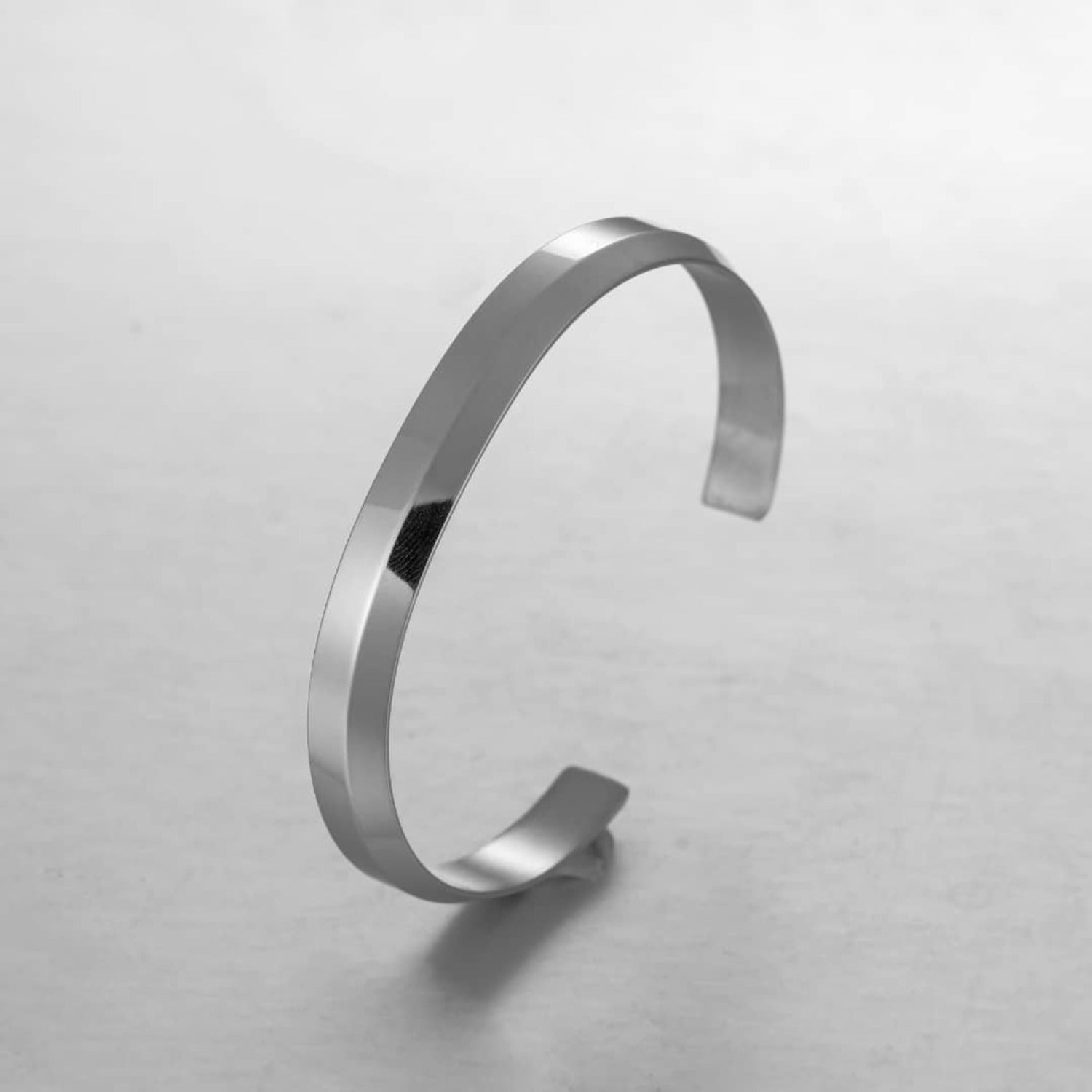 A sleek silver minimalist classic bracelet made from stainless steel, showcasing its elegant design and available sizes.