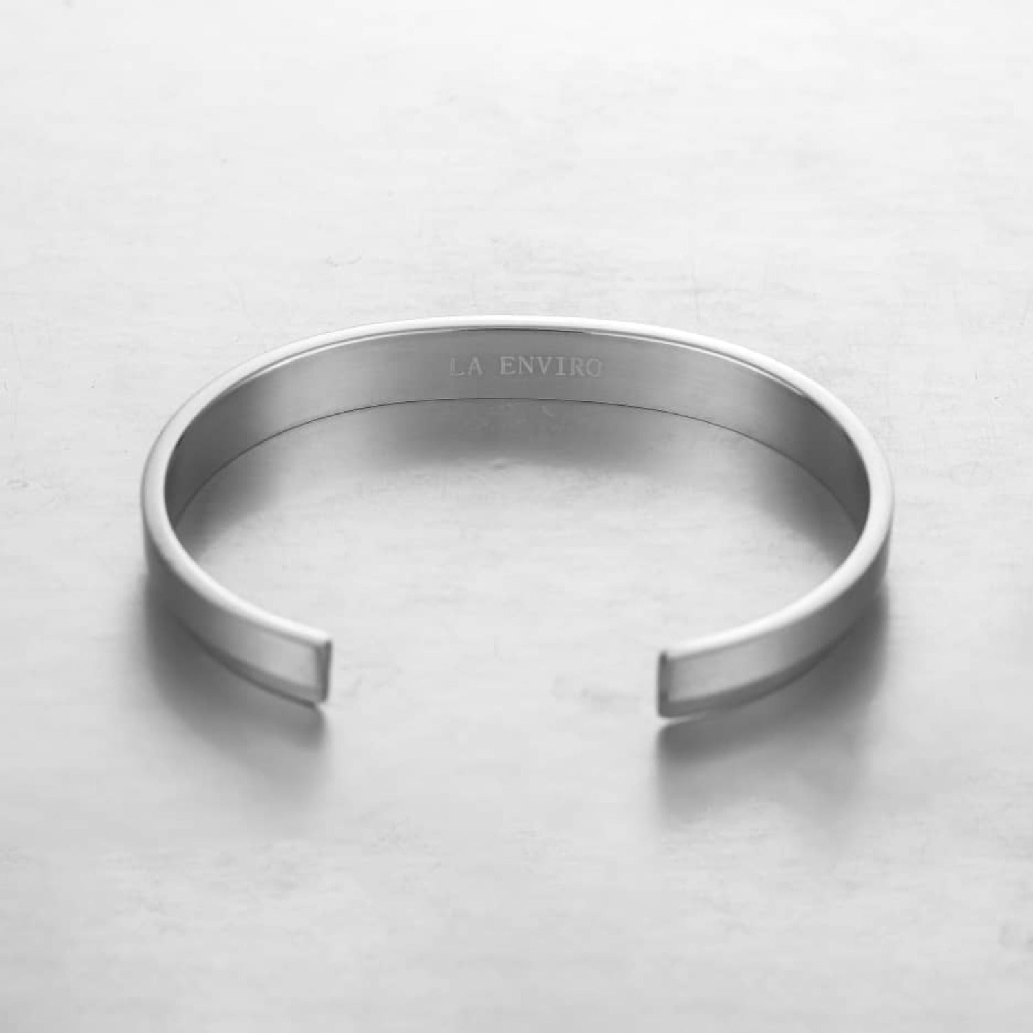 A sleek silver minimalist classic bracelet made from stainless steel, showcasing its elegant design and available sizes.