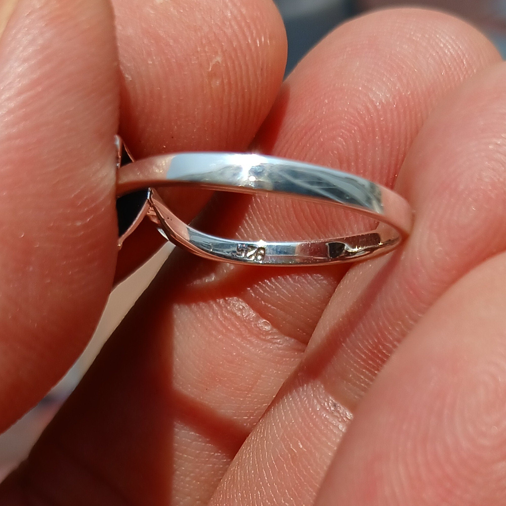 A stunning Minimalist Peridot Silver Ring featuring a unique triangle-shaped green Peridot stone set in a polished sterling silver band.