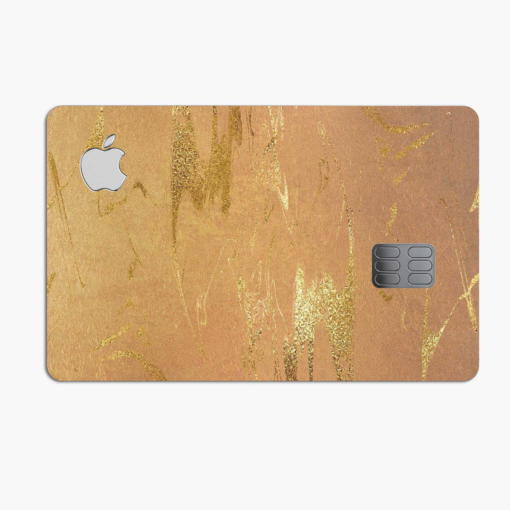 Molten Gold Digital Foil Swirl V8 skin applied on an Apple Card, showcasing its elegant design and protective features.