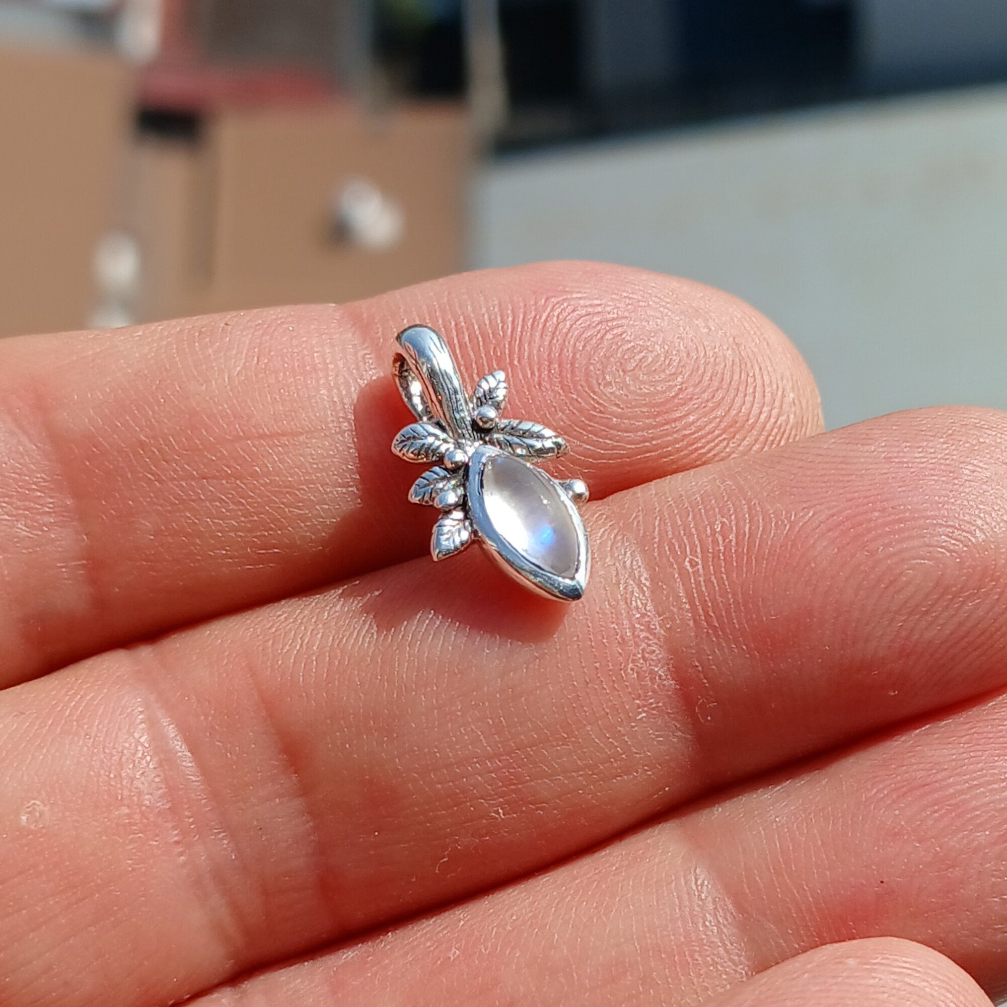 A beautiful Moonstone Pendant crafted in sterling silver, featuring a marquise-shaped Ceylon Moonstone with a delicate leaf design.