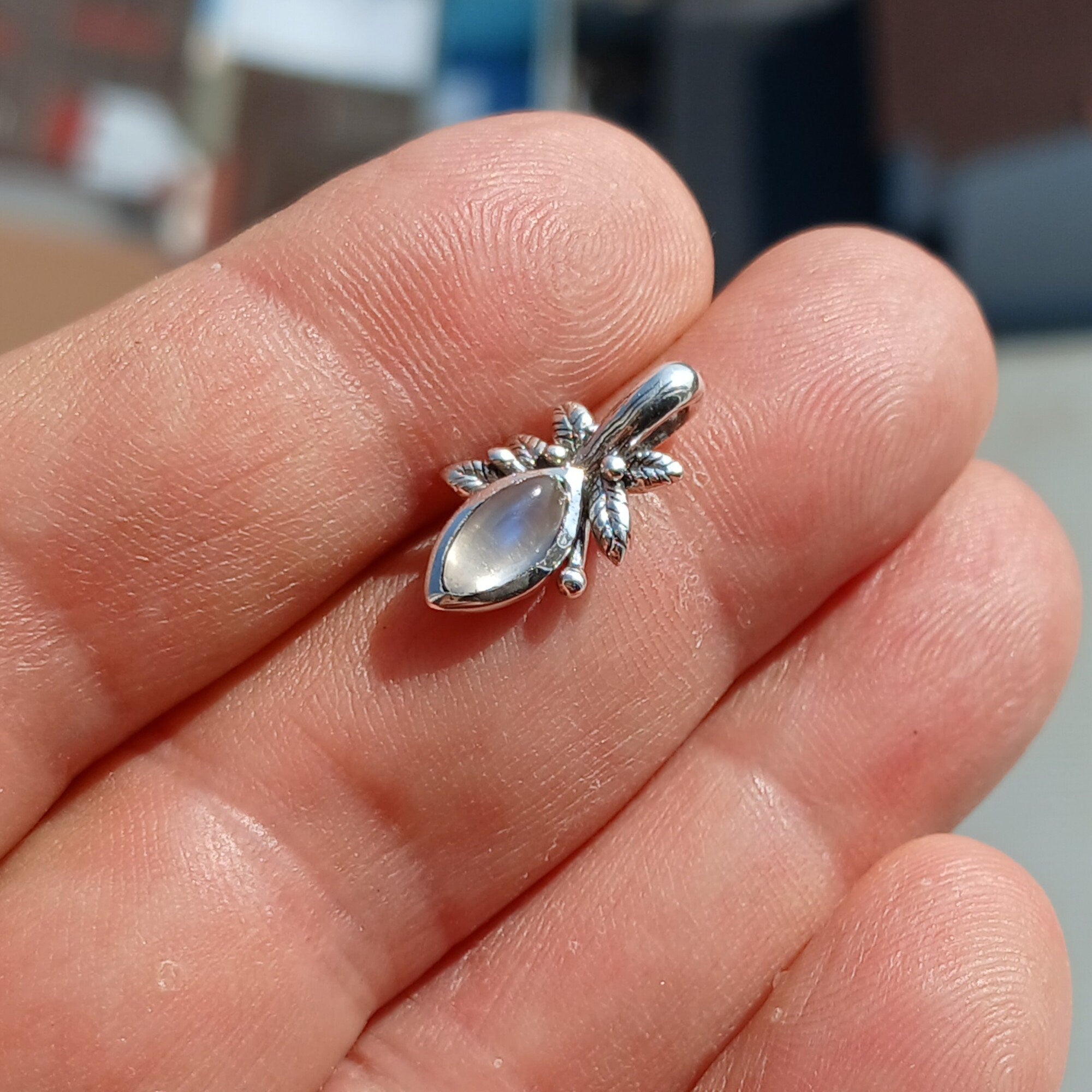 A beautiful Moonstone Pendant crafted in sterling silver, featuring a marquise-shaped Ceylon Moonstone with a delicate leaf design.