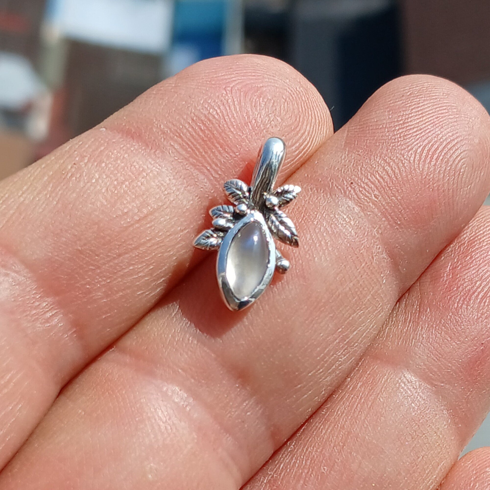 A beautiful Moonstone Pendant crafted in sterling silver, featuring a marquise-shaped Ceylon Moonstone with a delicate leaf design.