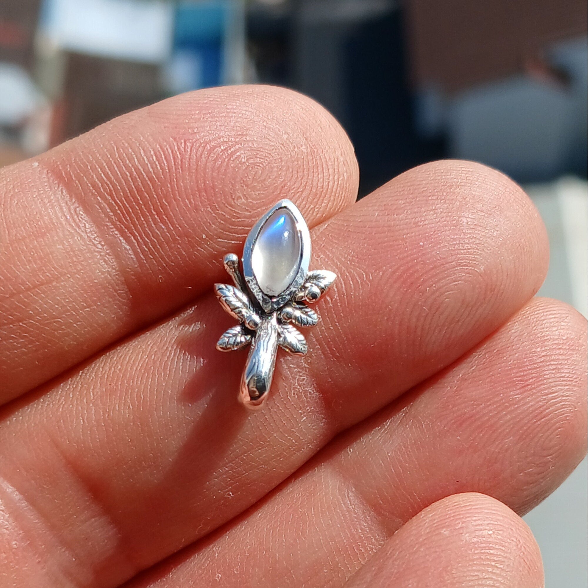 A beautiful Moonstone Pendant crafted in sterling silver, featuring a marquise-shaped Ceylon Moonstone with a delicate leaf design.