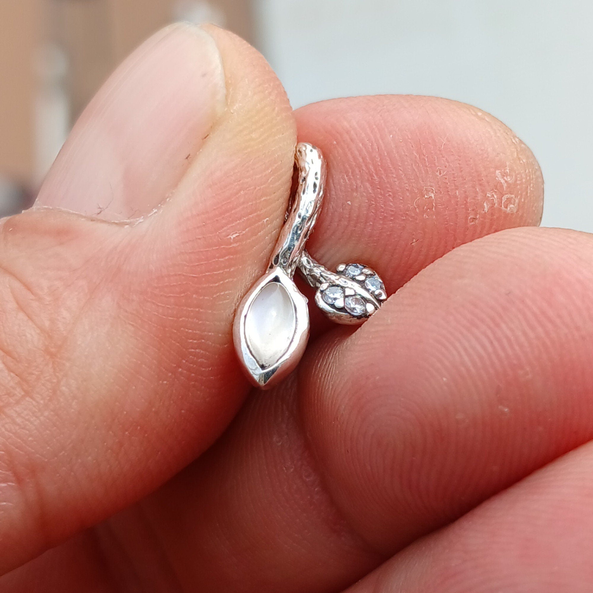 A stunning sterling silver moonstone pendant featuring a moonstone and cubic zirconia, showcasing its elegant design.