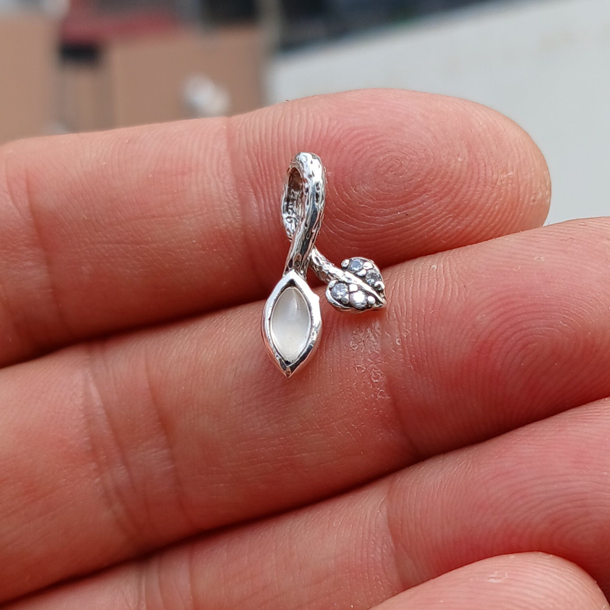 A stunning sterling silver moonstone pendant featuring a moonstone and cubic zirconia, showcasing its elegant design.