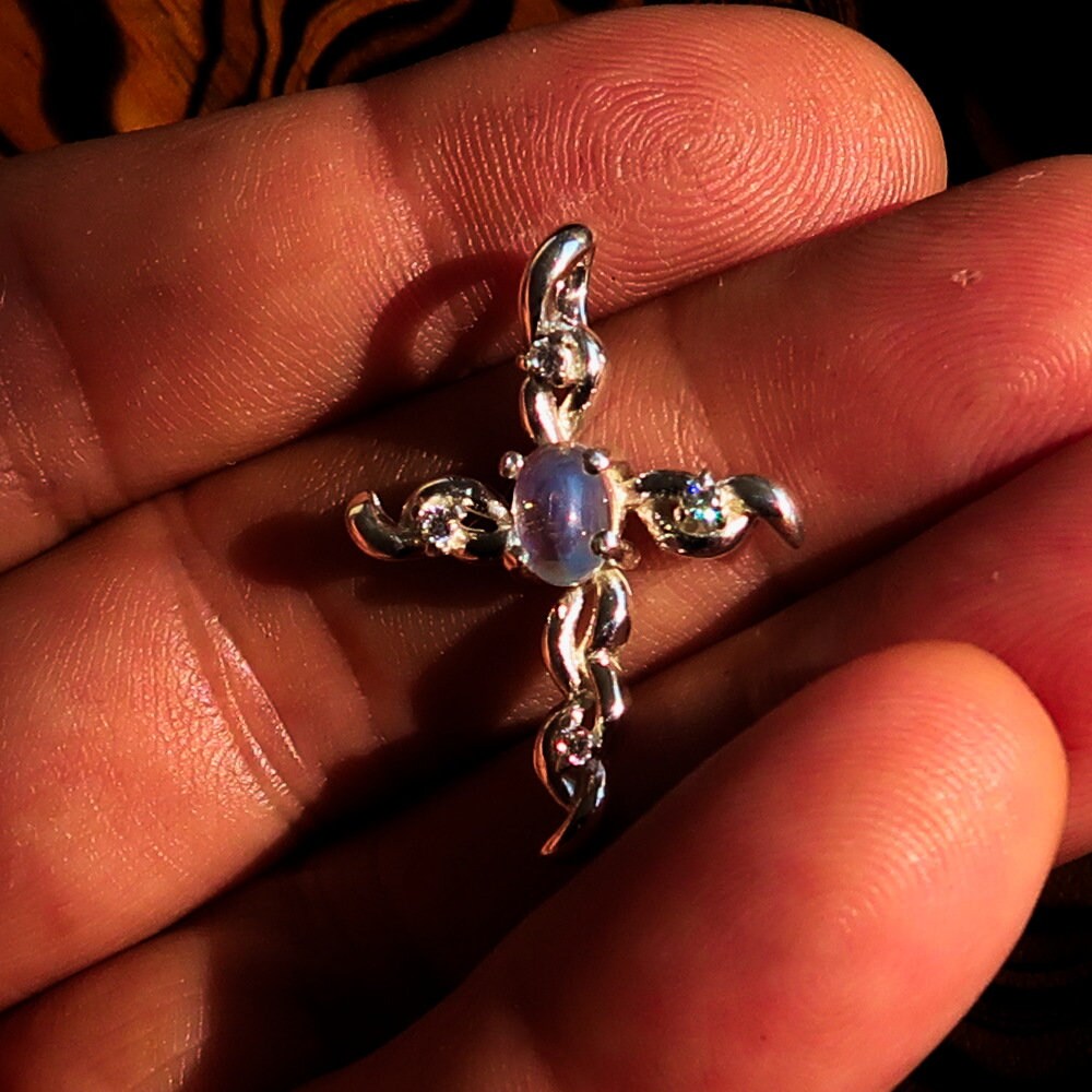 Sterling silver cross pendant featuring a moonstone and cubic zirconia, elegantly designed and hallmarked 925.