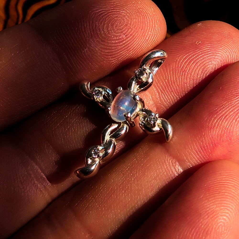 Sterling silver cross pendant featuring a moonstone and cubic zirconia, elegantly designed and hallmarked 925.