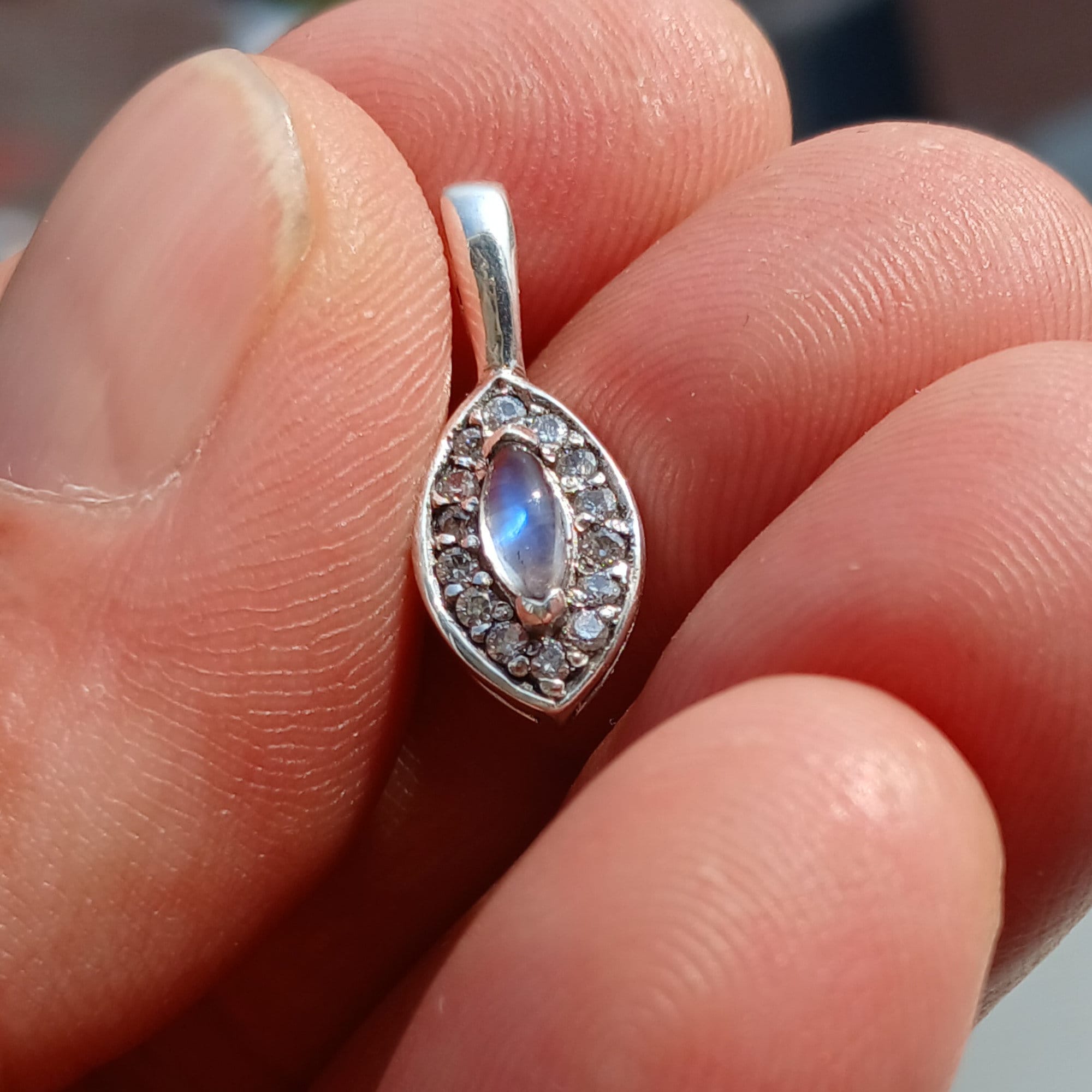 A beautiful Moonstone Pendant crafted in sterling silver, featuring a Ceylon Moonstone and sparkling CZ stones, showcasing elegance and charm.