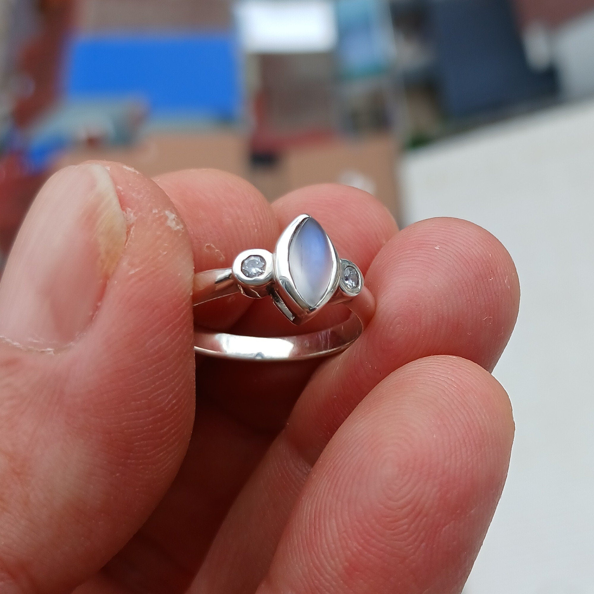 A stunning Moonstone Silver Ring featuring a marquise-shaped Moonstone and two sparkling CZ stones, set in polished Sterling Silver.