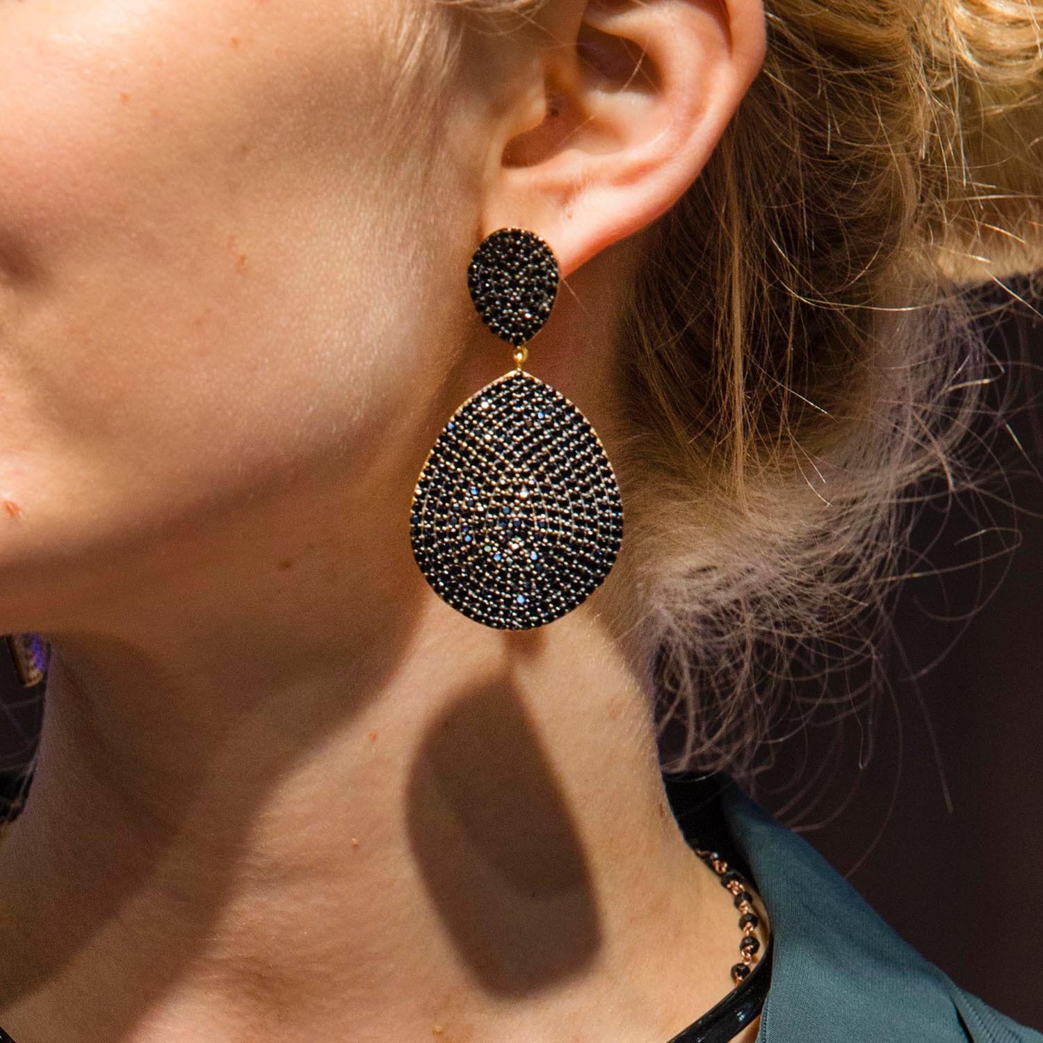 Monte Carlo Earrings featuring gold and black zircon, showcasing elegant design and luxurious materials.