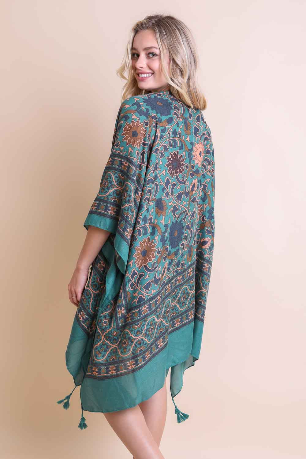 A stylish Moroccan Inspired Tapestry Kimono featuring vibrant colors and intricate patterns, perfect for layering over outfits.