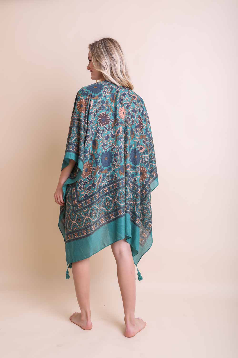 A stylish Moroccan Inspired Tapestry Kimono featuring vibrant colors and intricate patterns, perfect for layering over outfits.