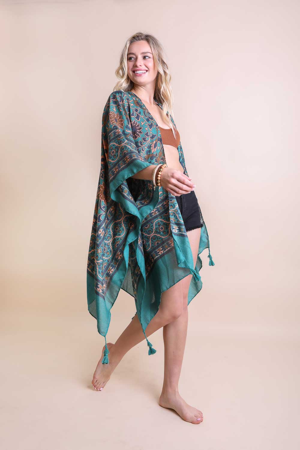 A stylish Moroccan Inspired Tapestry Kimono featuring vibrant colors and intricate patterns, perfect for layering over outfits.