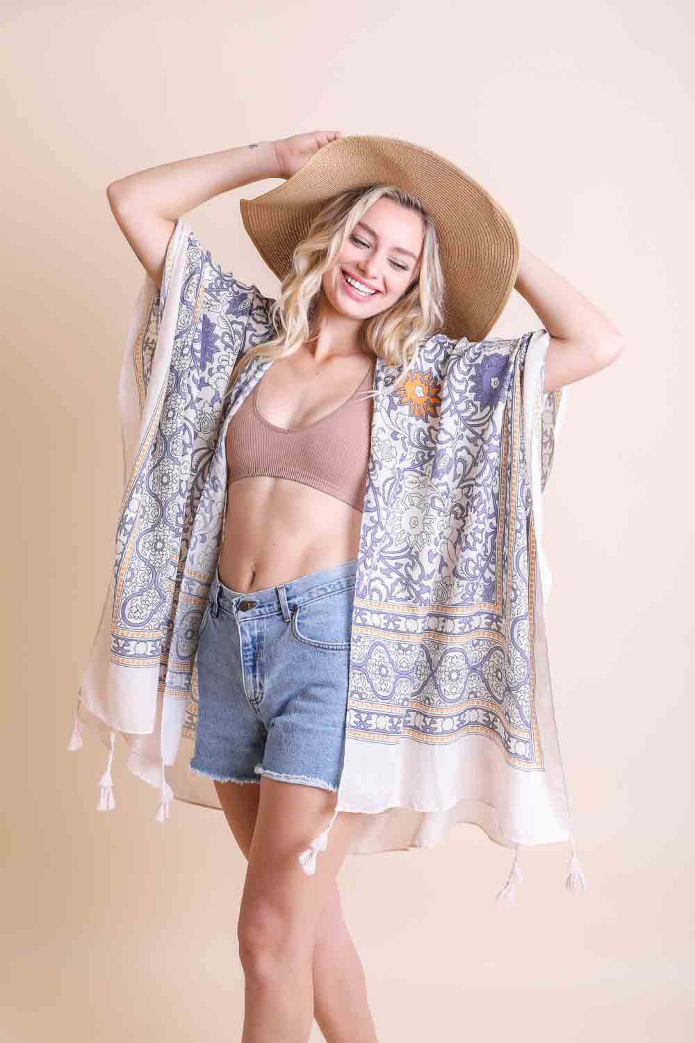 A stylish Moroccan Inspired Tapestry Kimono featuring vibrant colors and intricate patterns, perfect for layering over outfits.