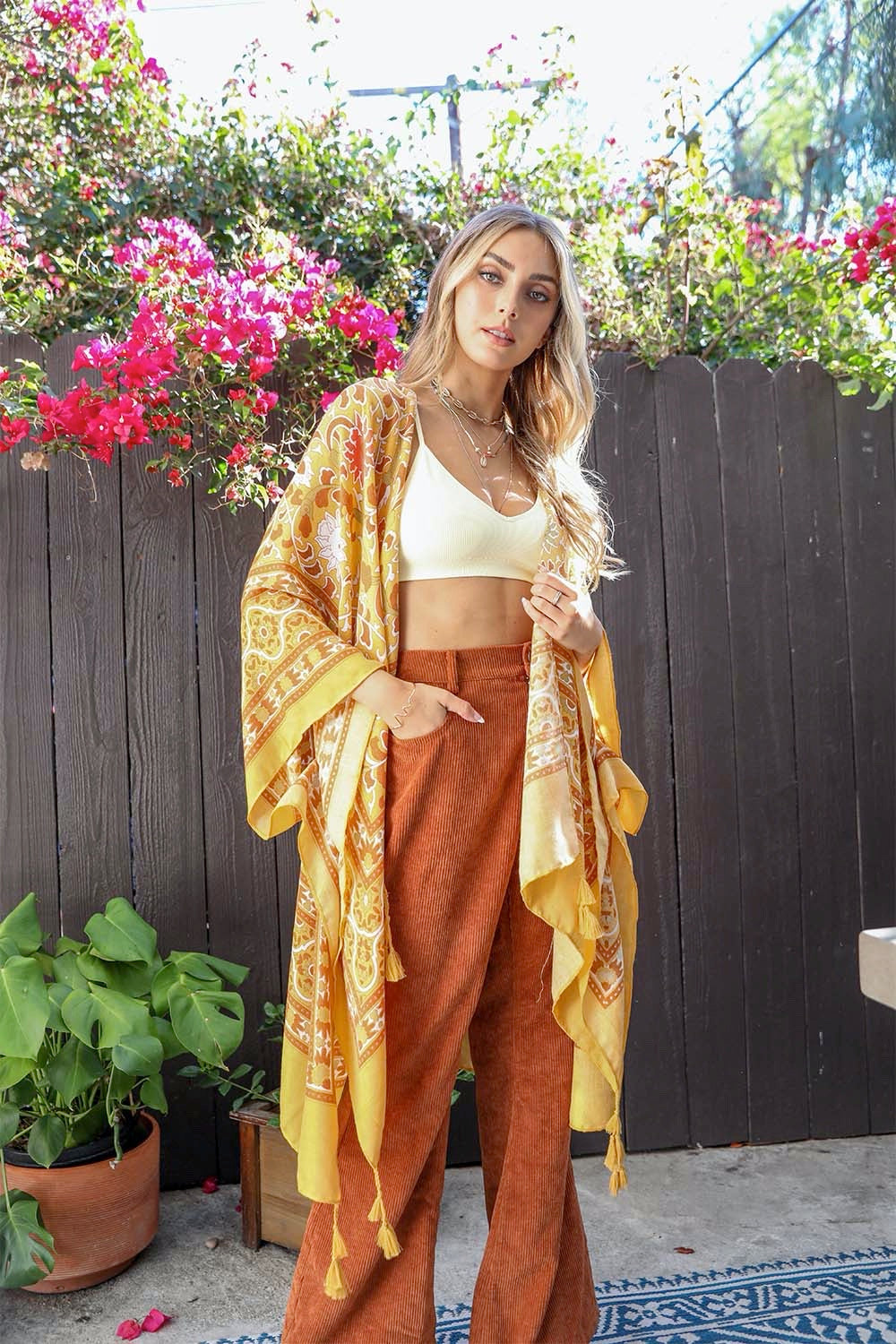 A stylish Moroccan Inspired Tapestry Kimono featuring vibrant colors and intricate patterns, perfect for layering over outfits.