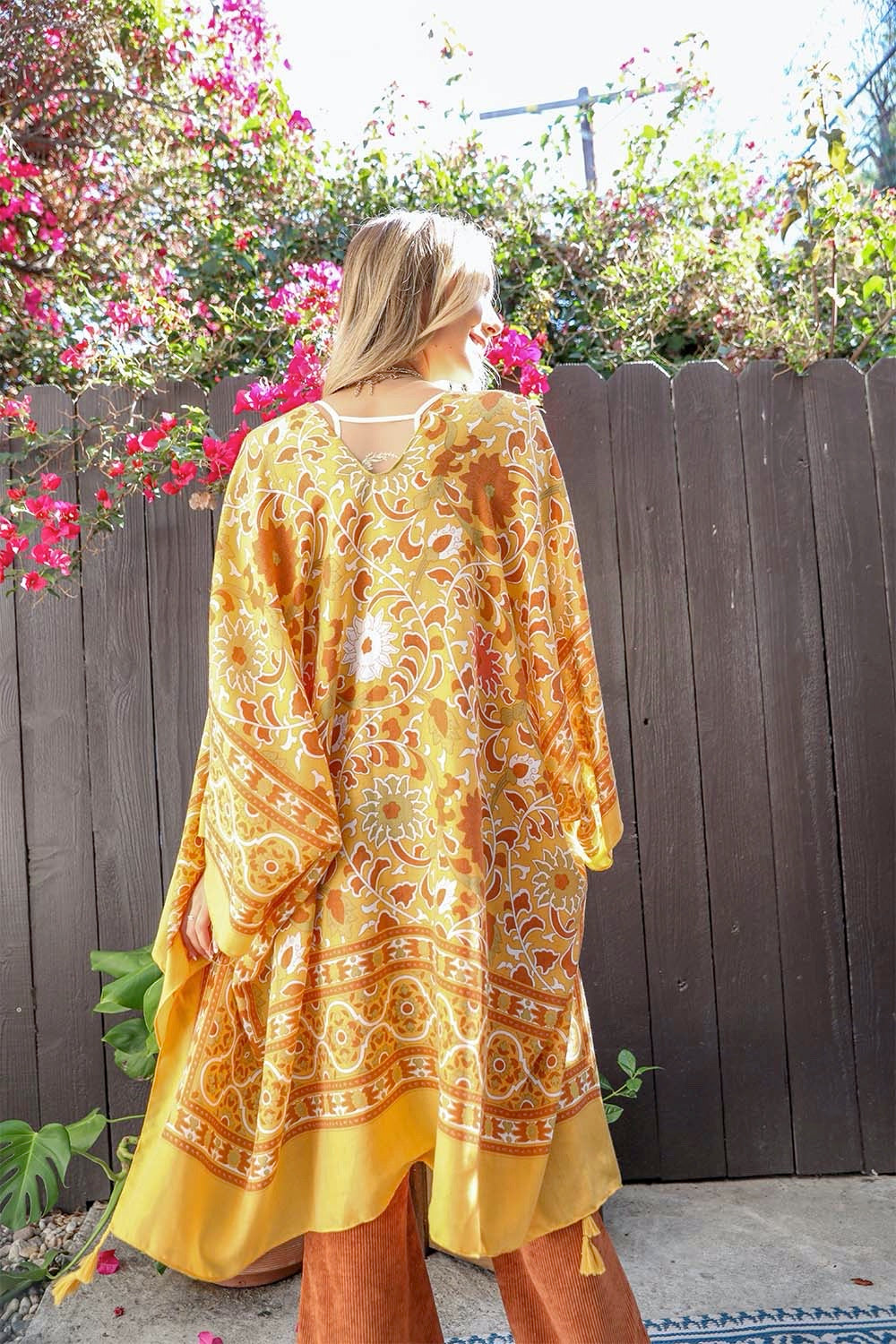 A stylish Moroccan Inspired Tapestry Kimono featuring vibrant colors and intricate patterns, perfect for layering over outfits.