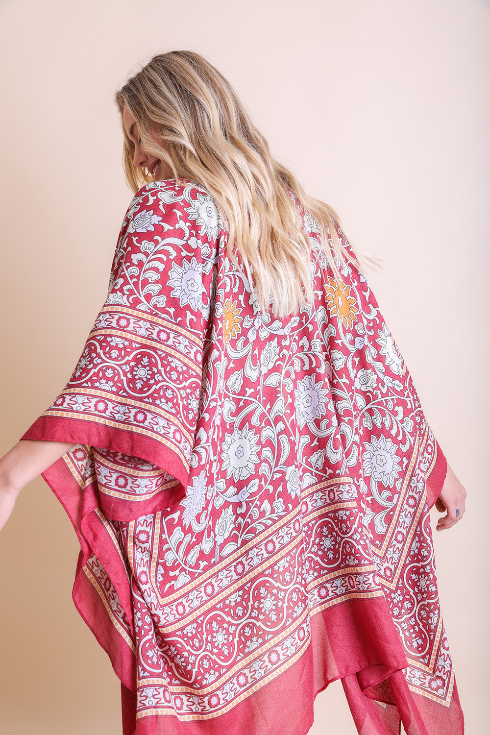 A stylish Moroccan Inspired Tapestry Kimono featuring vibrant colors and intricate patterns, perfect for layering over outfits.