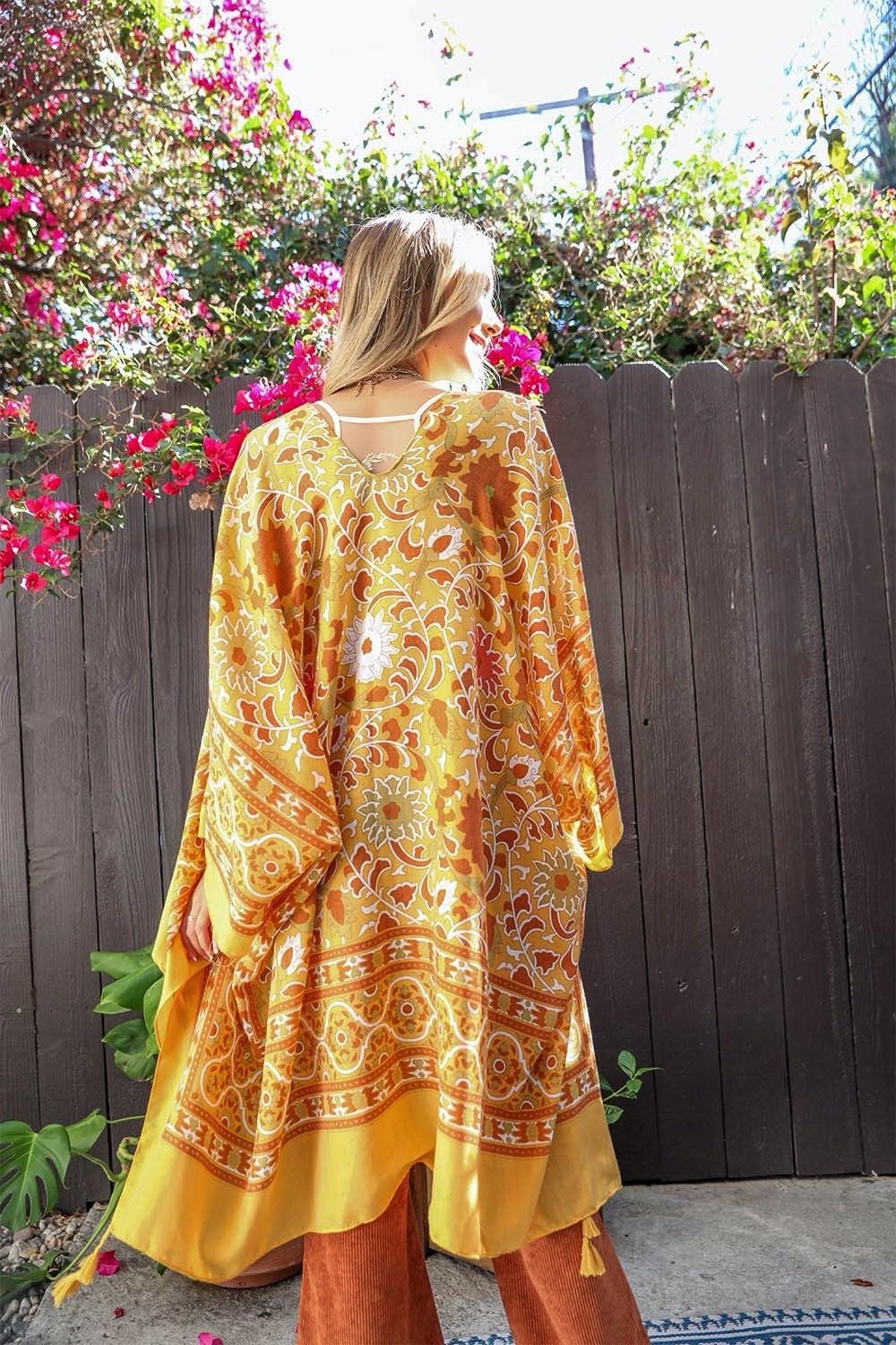 A stylish Moroccan Touch Tapestry Kimono featuring intricate tapestry patterns in vibrant colors, perfect for layering over outfits.