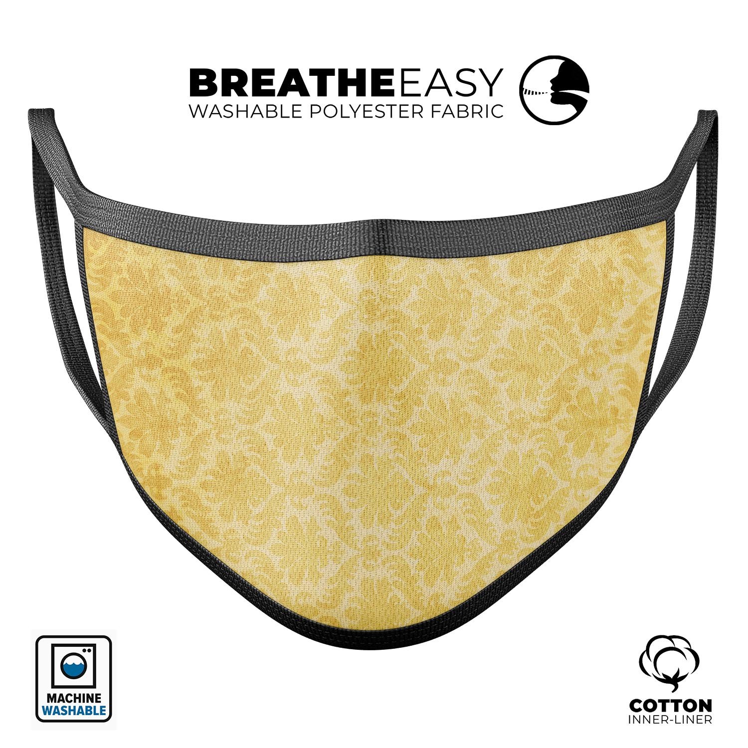 Mustard yellow damask pattern reusable mouth cover, showcasing adjustable ear loops and soft cotton interior, perfect for daily use.