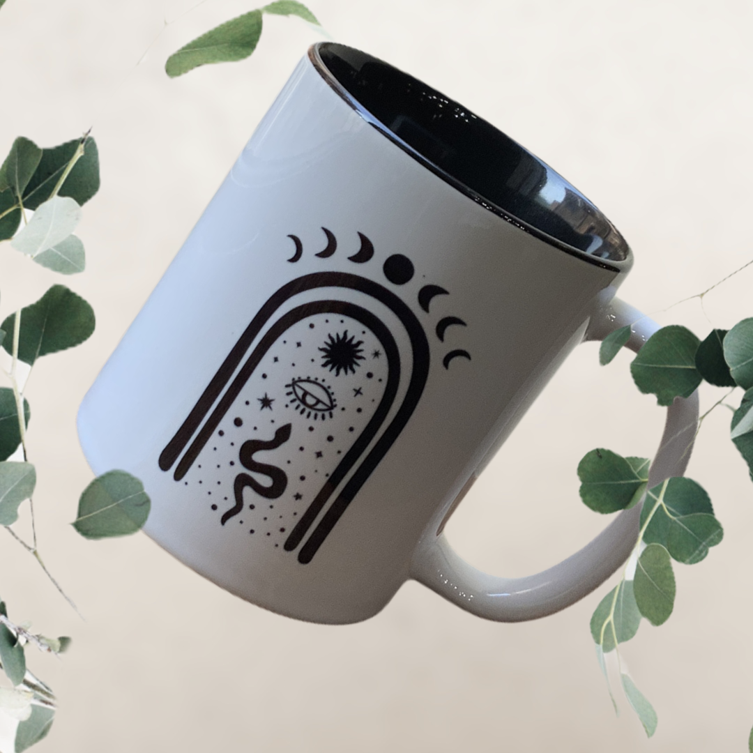 A beautifully designed ceramic mug featuring a mystical moon motif, perfect for coffee or wine.