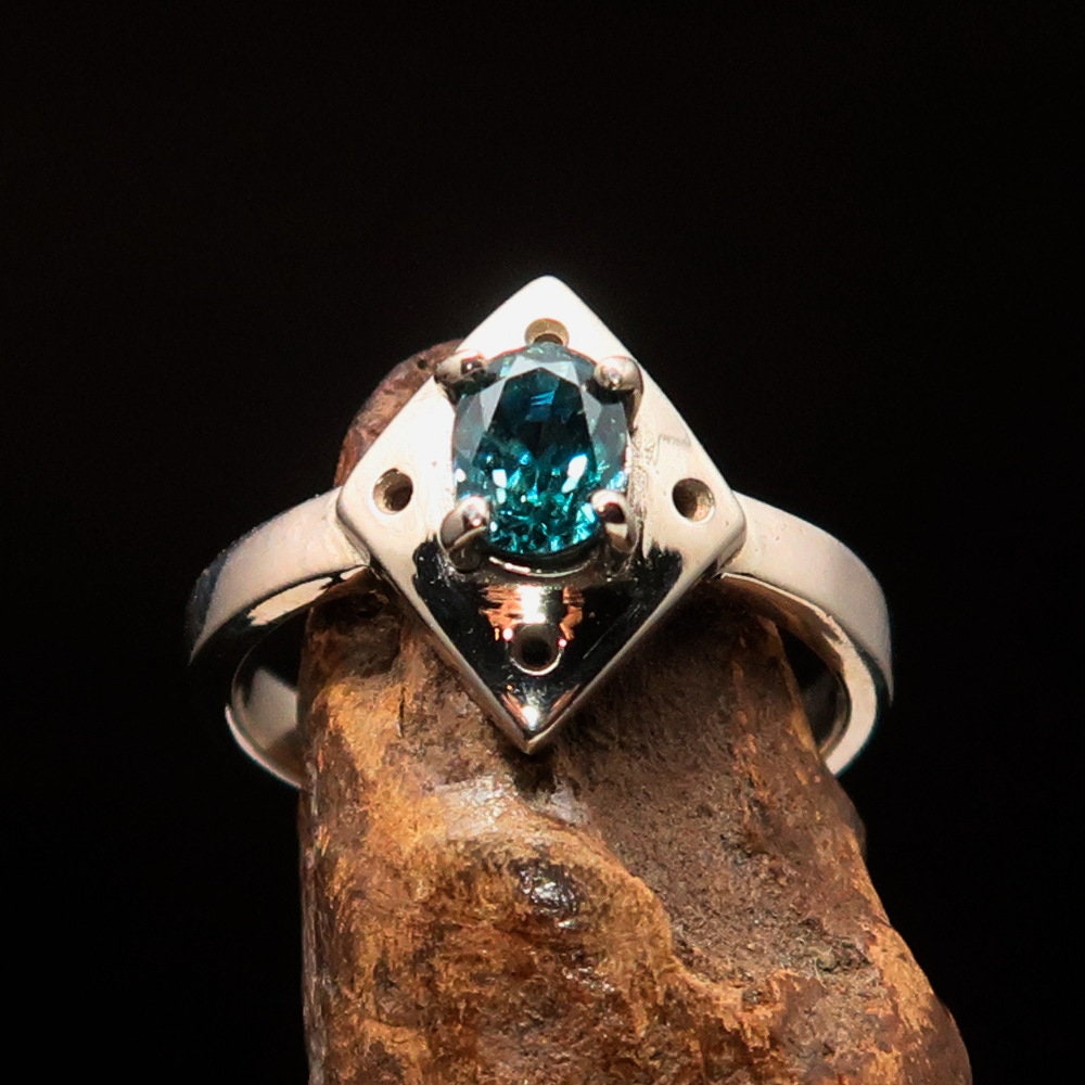 Handmade silver ring featuring a diamond-shaped blue Zircon gemstone, elegantly designed and polished.