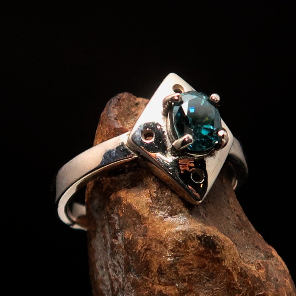 Handmade silver ring featuring a diamond-shaped blue Zircon gemstone, elegantly designed and polished.