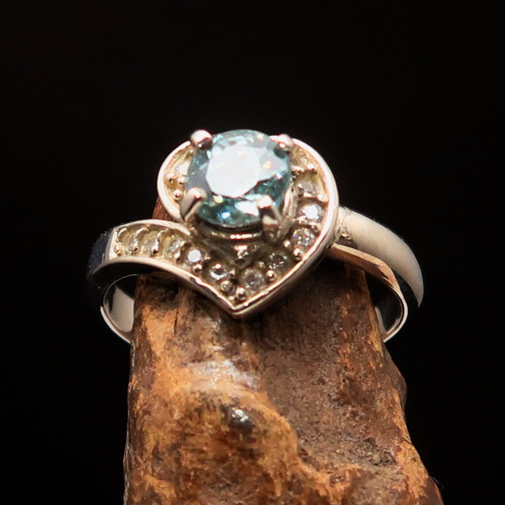 Natural Blue Zircon Ring featuring a heart-shaped gemstone set in polished sterling silver, showcasing its vibrant color and elegant design.