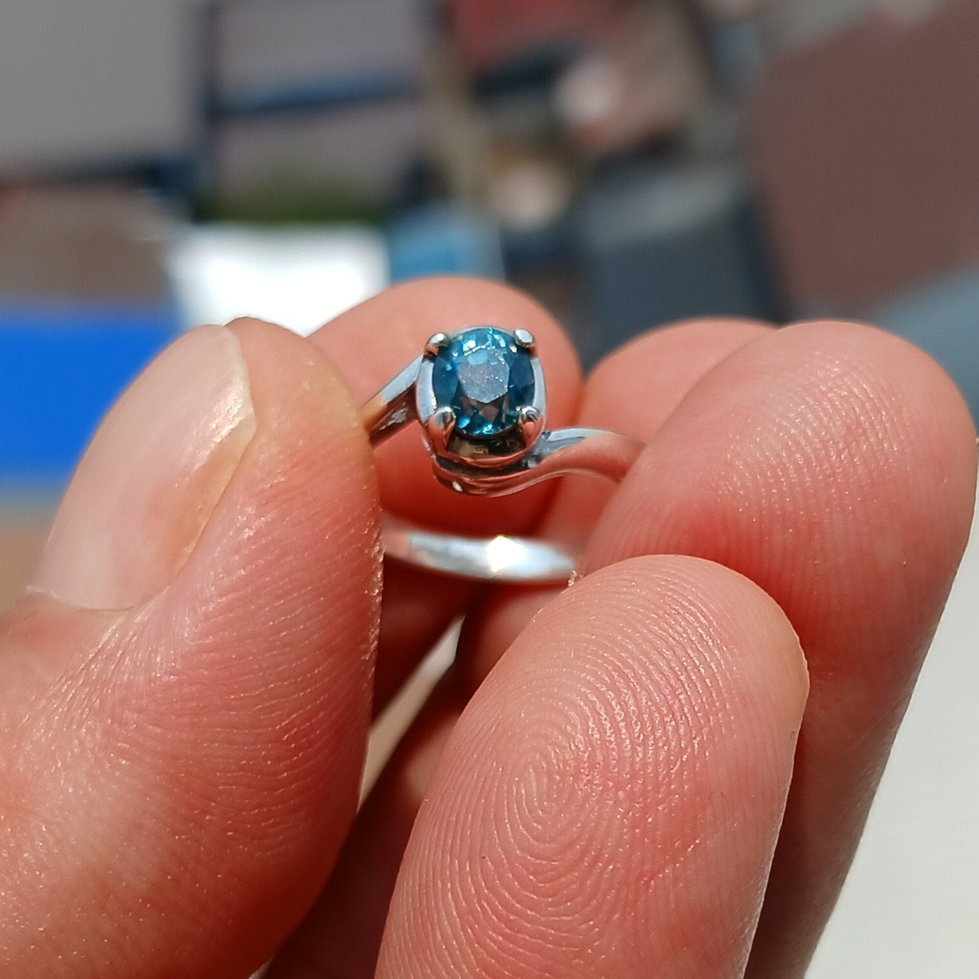 Natural Blue Zircon Ring in sterling silver with an oval cut gemstone, showcasing a unique design and hallmarked 925 quality.