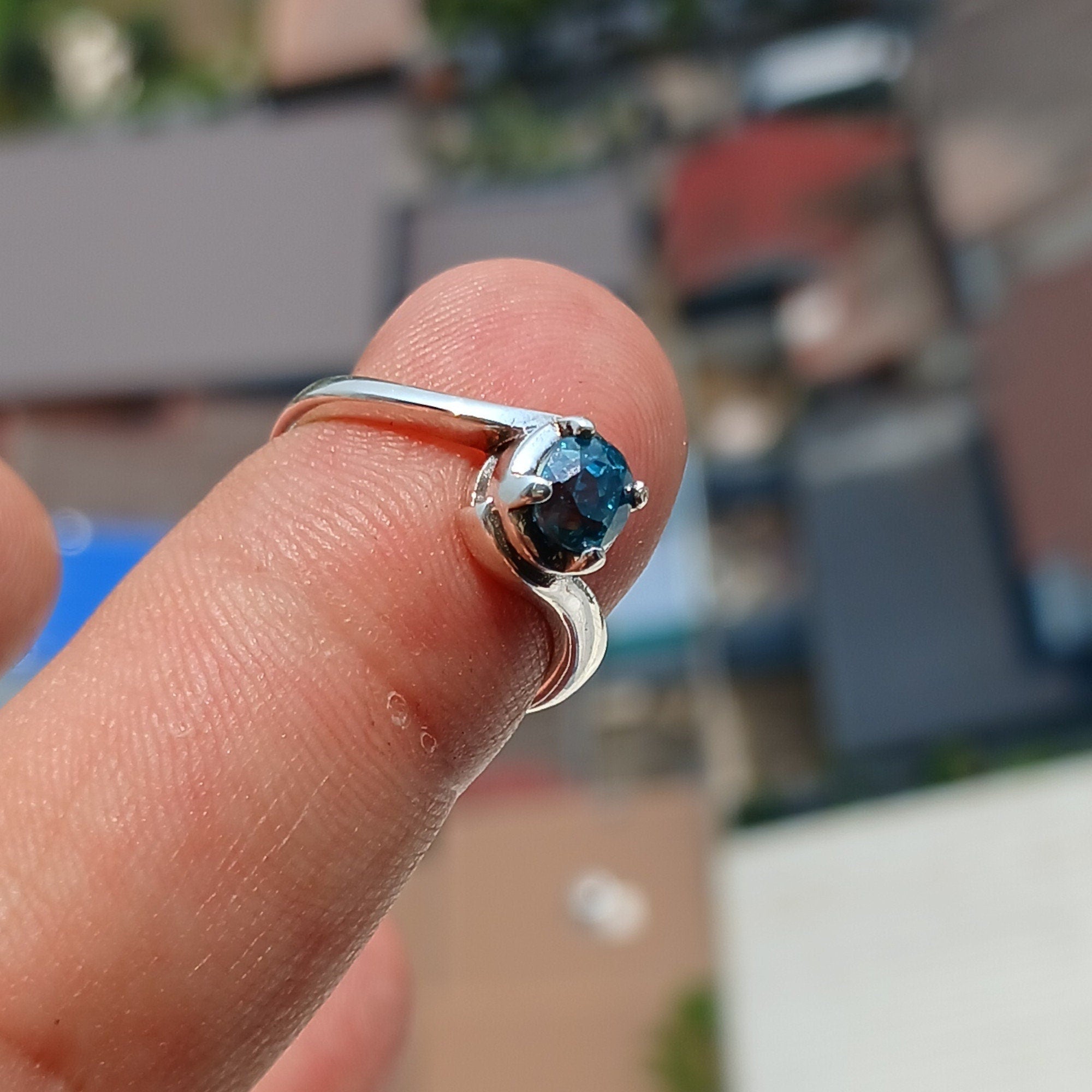 Natural Blue Zircon Ring in sterling silver with an oval cut gemstone, showcasing a unique design and hallmarked 925 quality.