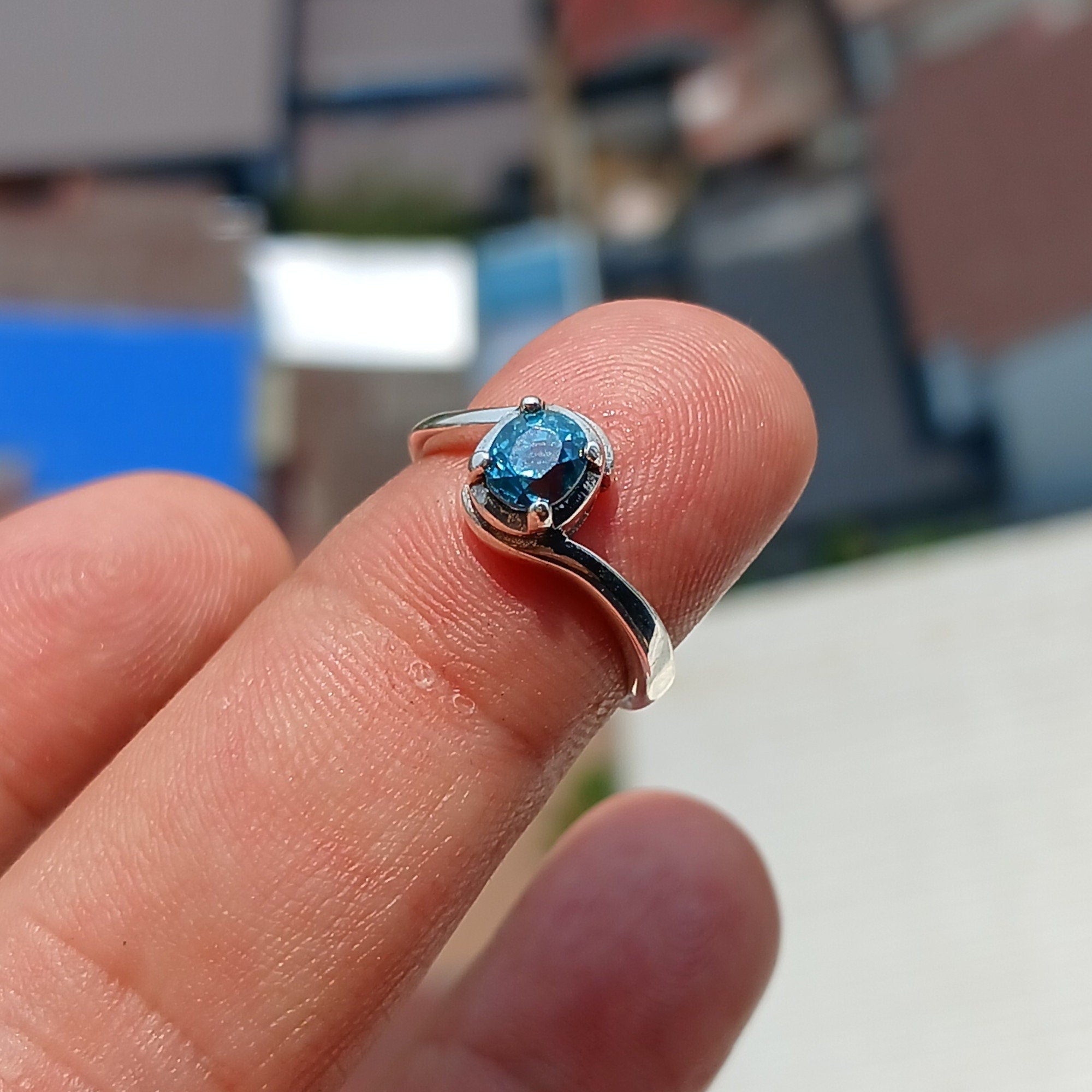 Natural Blue Zircon Ring in sterling silver with an oval cut gemstone, showcasing a unique design and hallmarked 925 quality.