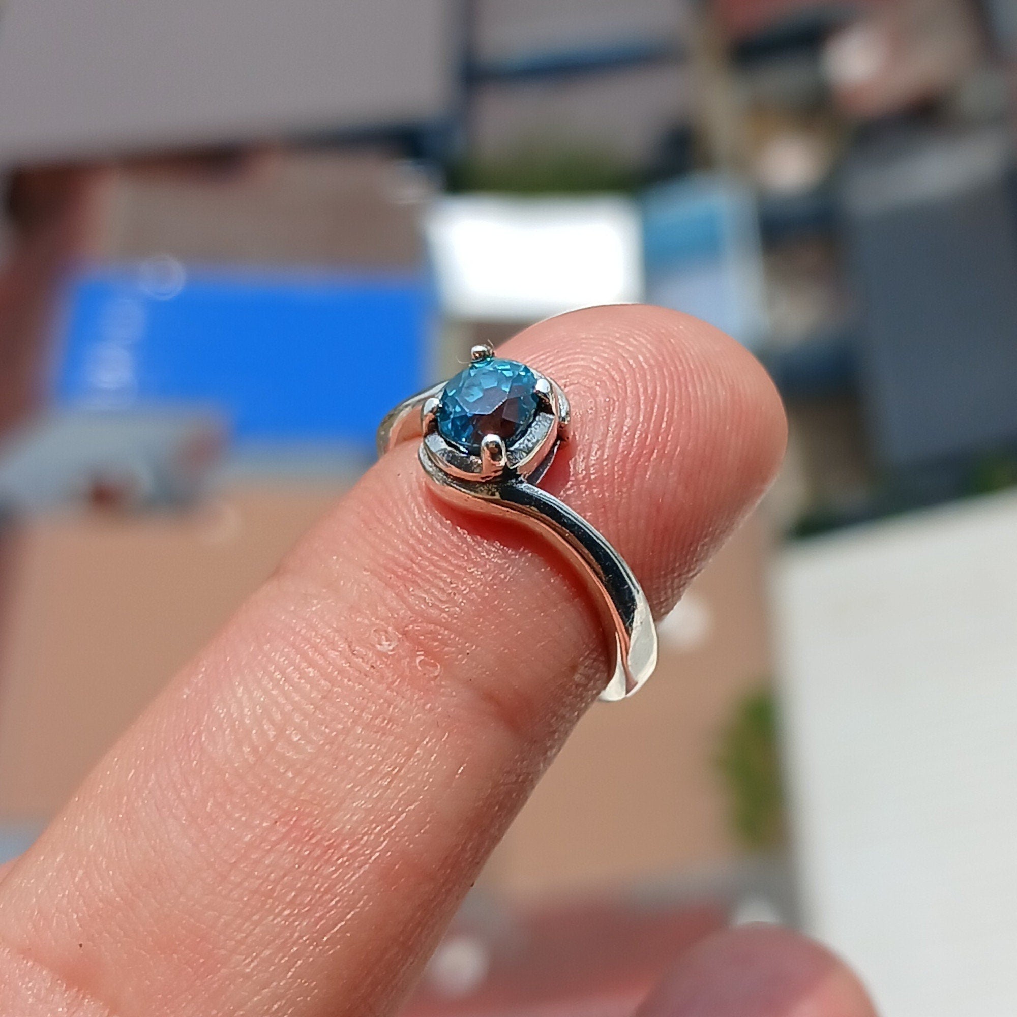 Natural Blue Zircon Ring in sterling silver with an oval cut gemstone, showcasing a unique design and hallmarked 925 quality.