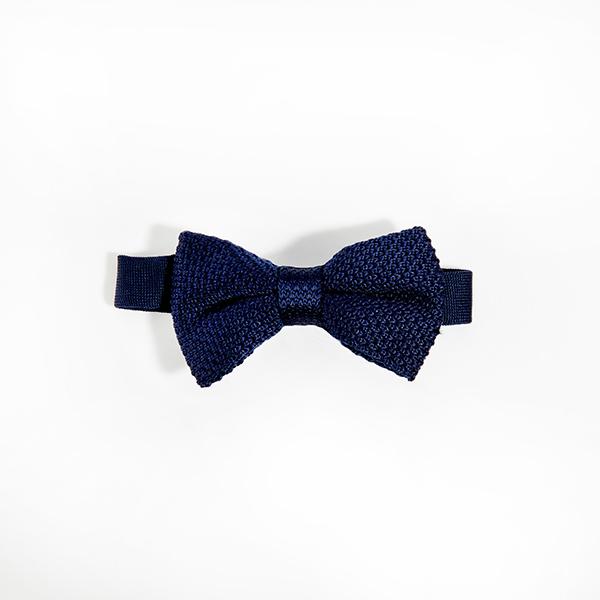 Navy blue knitted bow tie displayed on a white background, showcasing its texture and dimensions.