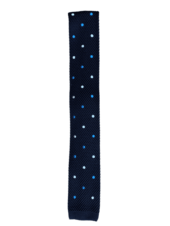 Navy blue knitted tie featuring white and baby blue polka dots, showcasing a square end design.