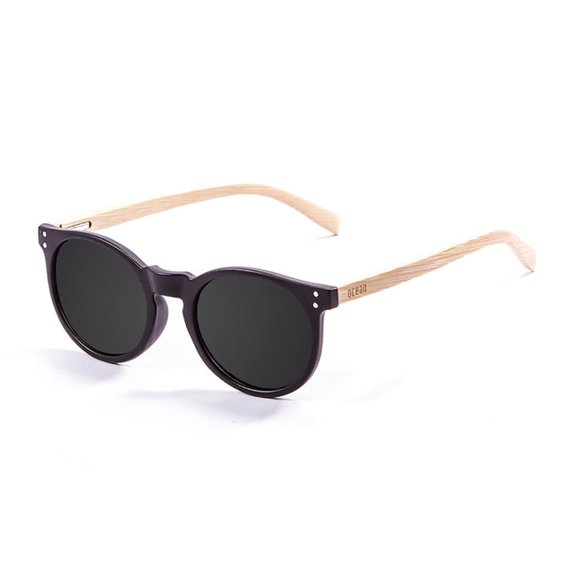 OCEAN GLASSES LIZARD WOOD 55000.1 featuring a round full-rimmed black plastic frame, suitable for unisex wear.