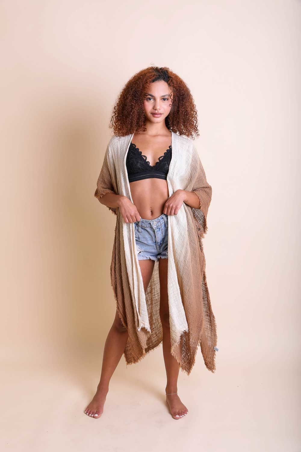 A lightweight ombre cotton kimono draped elegantly, showcasing its stylish design and armholes.