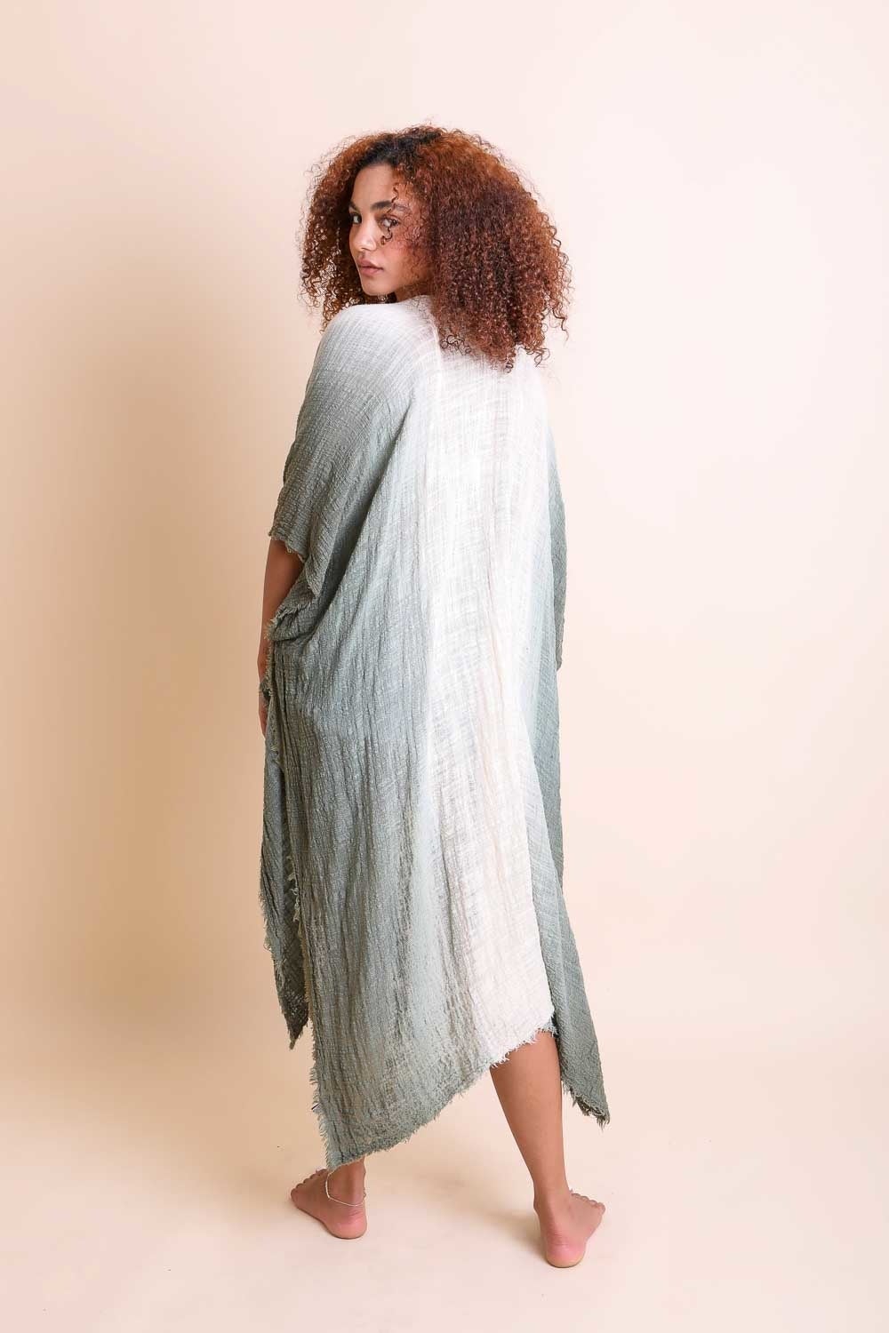 A lightweight ombre cotton kimono draped elegantly, showcasing its stylish design and armholes.