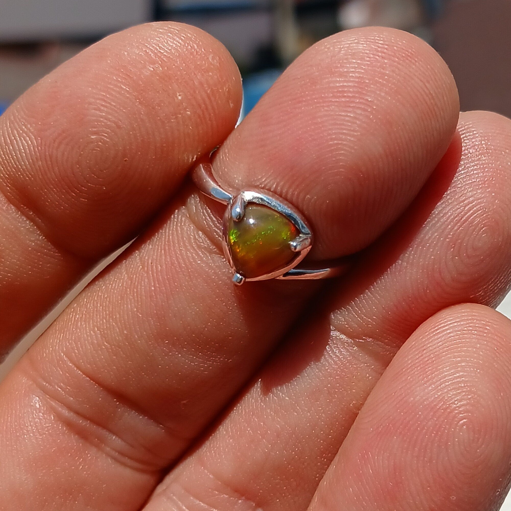 A stunning handcrafted sterling silver Opal Ring featuring a mesmerizing oval-shaped opal with vibrant colors and a mirror polished finish.